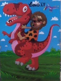 J riding a dino.jpeg
